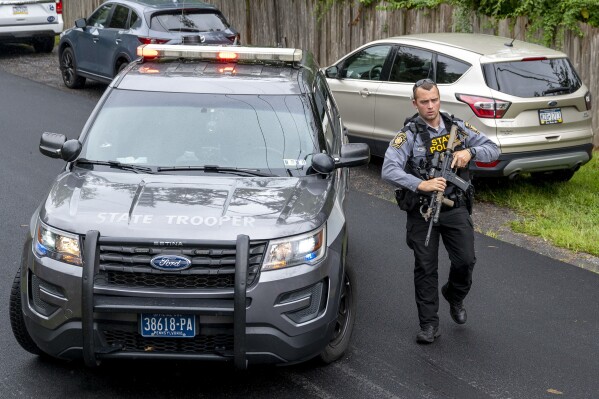 Pennsylvania State Troopers and other law enforcement officers are on the scene in Nantmeal Village as the search for escaped convict Danilo Cavalcante moved to northern Chester County, Sunday, Sept. 10, 2023. (Tom Gralish/The Philadelphia Inquirer via AP)