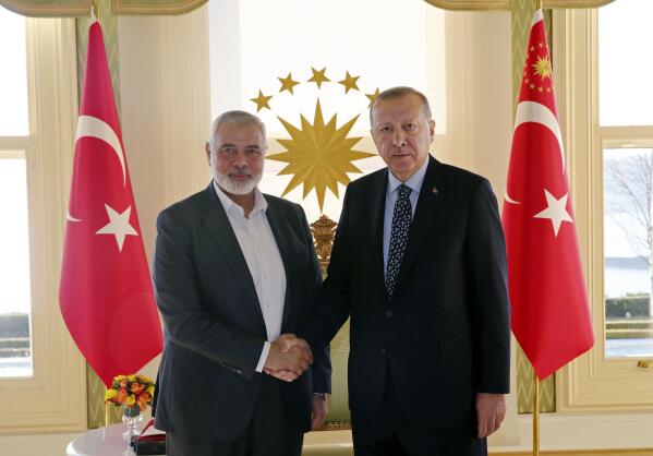 FILE - In this Feb. 1, 2020 file photo, Turkey's President Recep Tayyip Erdogan, right, shakes hands with Hamas movement chief Ismail Haniyeh, prior to their meeting in Istanbul. When the Palestinians last held elections 15 years ago, the Islamic militant group Hamas won a landslide victory after campaigning as a scrappy resistance movement. That will be a harder sell this time around. Top Hamas officials have decamped to luxury hotels in Turkey and Qatar, leaving ordinary Palestinians to suffer the consequences of their policies. (Presidential Press Service via AP, Pool, File)