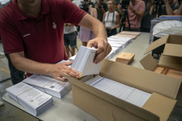 FILE - An election worker shows ballots to the media before being distributed at polling stations, at a warehouse in Barcelona, Spain, July 18, 2023. Claims of vote rigging and election fraud are spreading in Spain ahead of that nation's pivotal election on Sunday. The allegations are strikingly similar to claims spread by ex-President Donald Trump and others in the United States ahead of the 2020 election. (AP Photo/Emilio Morenatti, File)