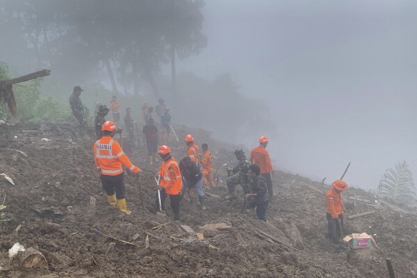 In this photo released by the Indonesian National Search and Rescue Agency (BASARNAS), rescuers search for survivors at a village hit by a landslide in Tana Toraja district of South Sulawesi province, Indonesia, Monday, April 15, 2024. A search and rescue team found multiple people killed by landslides on Indonesia's Sulawesi island and are still looking for a few missing, officials said Monday. (National Search and Rescue Agency via AP)