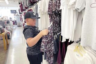 Jace Hill, 12, shops for Mississippi State University apparel at The Lodge in Starkville, Miss., Wednesday, July 22, 2021. Many Starkville retailers have seen an influx of sales since the National Championship win. (Tyler B. Jones/The Commercial Dispatch via AP)