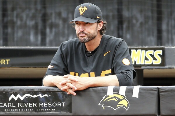 FILE - Tennessee head coach Tony Vitello stands in the dugout during a lighting delay in an NCAA college baseball tournament super regional game against Southern Mississippi in Hattiesburg, Miss., Saturday, June 10, 2023. Vitello has built his offense around the long ball. No team in the country has hit more homers than the Volunteers' 500 since 2020. (James Pugh/impact601.com via AP, File, File)