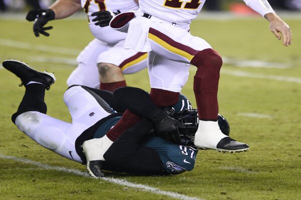 Washington Football Team's Alex Smith (11) is tackled by Philadelphia Eagles' Malik Jackson (97) during the second half of an NFL football game, Sunday, Jan. 3, 2021, in Philadelphia. (AP Photo/Derik Hamilton)