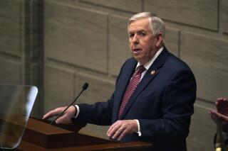 FILE - In this Jan. 27, 2021 file photo, Missouri Gov. Mike Parson delivers the State of the State address in Jefferson City, Mo. Missouri is clashing with the U.S. Department of Justice over a new law banning police from enforcing federal gun rules. In a letter obtained by The Associated Press, Justice Department officials wrote that state lawmakers went too far with the law and noted that federal law trumps state law under the U.S. Constitution's Supremacy Clause. In response, Parson and Attorney General Eric Schmitt wrote a defiant letter stating that they still plan to enforce the new law. (AP Photo/Jeff Roberson, File)