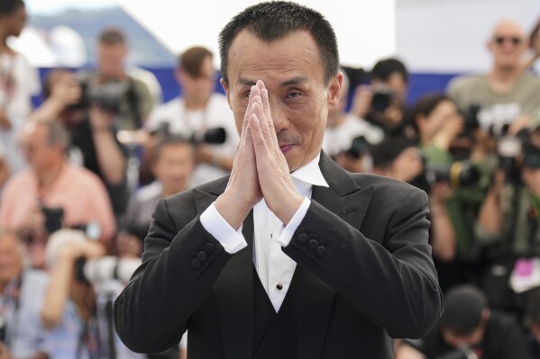 Yongzhong Chen poses for photographers at the photo call for the film "Resurrection" at the 78th international film festival in Cannes, southern France, Friday, May 23, 2025. (AP Photo/Natacha Pisarenko)