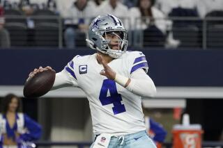 FILE - Dallas Cowboys quarterback Dak Prescott (4) looks before throwing a pass in the first half of an NFL wild-card playoff football game against the San Franciso 49ers in Arlington, Texas, Sunday, Jan. 16, 2022. Prescott had surgery on his non-throwing shoulder after the season, a procedure coach Mike McCarthy said was a clean-up for an issue that isn't a concern. McCarthy told reporters at the scouting combine Tuesday, March 1, 2022, he expects Prescott to be available for offseason work. (AP Photo/Tony Gutierrez, File)