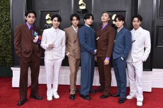 FILE - BTS arrives at the 64th Annual Grammy Awards on April 3, 2022, in Las Vegas. The group says they are taking time to focus on solo projects. The seven-member group with hits like “Butter” and “Dynamite” talked about their future in a video posted June 14, celebrating the nine year anniversary of their debut release.  (Photo by Jordan Strauss/Invision/AP, File)