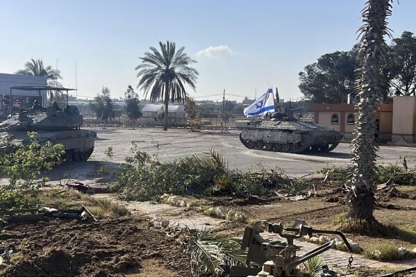 This photo provided by the IDF shows a tank with the Israeli flag entering the Gaza side of the Rafah border crossing, Tuesday, May 7, 2024. (Israel Defense Forces via AP)