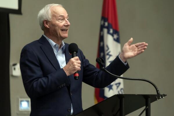 FILE - In this July 15, 2021, file photo, Arkansas Gov. Asa Hutchinson speaks during a town hall meeting in Texarkana, Ark. Hutchinson is Arkansas' top Republican and is leaving office in January with strong approval numbers, but he's been conspicuously absent from his state's primary campaigns. Other top GOP figures like former President Donald Trump, Sen. Tom Cotton and Sarah Sanders are instead frequenting the state's airwaves leading up to Tuesday, May 24, 2022 election.  (Kelsi Brinkmeyer/The Texarkana Gazette via AP, File)