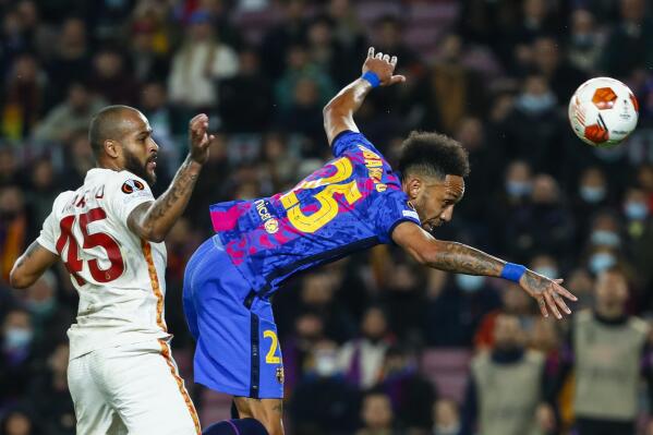 Barcelona's Pierre-Emerick Aubameyang, right, vies for the ball with Galatasaray's Marcao during the Europa League, round of 16, first leg soccer match between FC Barcelona and Galatasaray at the Camp Nou stadium in Barcelona, Spain, Thursday, March 10, 2022. (AP Photo/Joan Monfort)