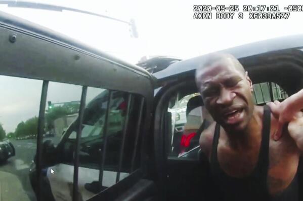 FILE - In this image from police body camera video shown as evidence in court, Minneapolis police officers attempt to place George Floyd in a police vehicle, on May 25, 2020, outside Cup Foods in Minneapolis. Former police Officers Tou Thao, J. Alexander Kueng and Thomas Lane are on trial in federal court accused of violating Floyd's civil rights as fellow Officer Derek Chauvin killed him. (Minneapolis Police Department via AP, File)