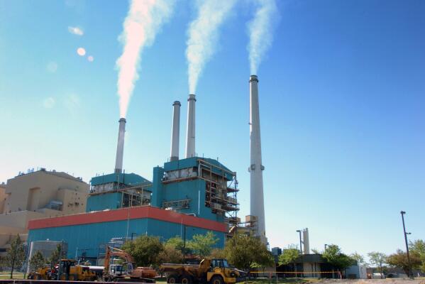 FILE - In this July 1, 2013, file photo, smoke rises from the Colstrip Steam Electric Station, a coal burning power plant in in Colstrip, Mont. A divided Supreme Court on Monday ruled against the Obama administration’s attempt to limit power plant emissions of mercury and other hazardous air pollutants, but it may only be a temporary setback for regulators who will have another chance to get the process right. The justices split 5-4 along ideological lines to rule that the Environmental Protection Agency failed to take cost into account when it first decided to regulate the toxic emissions from coal- and oil-fired plants.  (AP Photo/Matthew Brown, File)