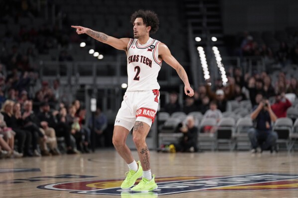 Texas Tech guard Pop Isaacs celebrates after sinking a three-point basket in the first half of an NCAA college basketball game against Vanderbilt in Fort Worth, Texas, Saturday, Dec. 16, 2023. (AP Photo/Tony Gutierrez)