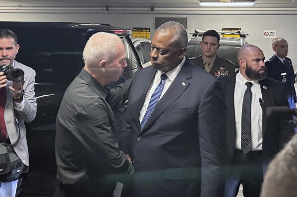 U.S. Defense Secretary Lloyd Austin, right, is greeted by Israel’s Minister of Defense Yoav Gallant as he arrives at the Ministry of Defense, Friday, Oct. 13, 2023, in Tel Aviv. Austin is in Israel for meetings with senior government leaders and to see firsthand some of the U.S. weapons and security assistance that Washington rapidly delivered to Israel in the first week of its war with the militant Hamas group. (AP Photos/Lolita Baldor)