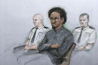 This court artist sketch by Elizabeth Cook shows Ali Harbi Ali in the dock at the Old Bailey accused of stabbing to death Conservative MP for Southend West David Amess, in London, Monday March 21, 2022.  A prosecutor says a man who stabbed a veteran British lawmaker to death while he was meeting voters last year was a “committed Islamist terrorist” who had spent years researching and planning potential attacks on lawmakers. Ali Harbi Ali, 26, appeared in the dock Monday at London’s Central Criminal Court as a trial opened into the murder of Conservative lawmaker David Amess. (Elizabeth Cook/PA via AP)