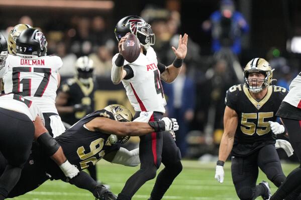 New Orleans Saints defensive end Marcus Davenport (92) hits Atlanta Falcons quarterback Desmond Ridder (4) as he throws in the first half of an NFL football game in New Orleans, Sunday, Dec. 18, 2022. (AP Photo/Gerald Herbert)