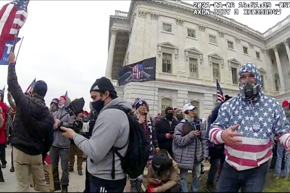 This image from police body-worn video and contained in the Justice Department statement of facts supporting the arrest of Carlos Ayala, shows Ayala outside the U.S. Capitol on Jan. 6, 2021, in Washington. Ayala, a Republican member of the Maryland State Board of Elections, was arrested on Tuesday, Jan. 9, 2024, in Maryland, on felony and misdemeanor charges for participating in the Jan. 6 rioting. Michael Summers, the chair of the Maryland elections board, said in a statement Thursday, Jan. 11, he has accepted Ayala's immediate resignation. (Department of Justice via AP)