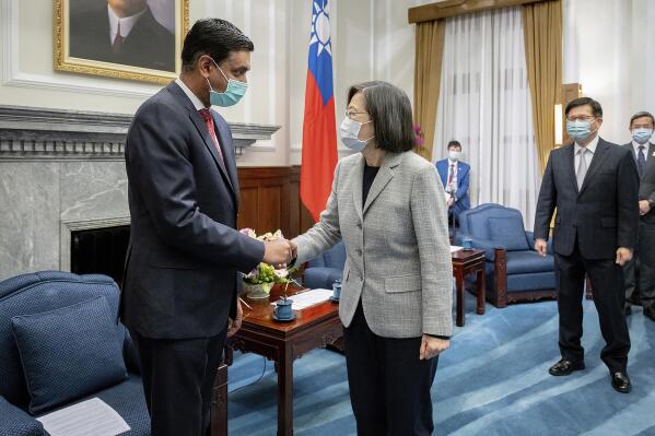 In this photo released by the Taiwan Presidential Office, Taiwan's President Tsai Ing-wen, center, shakes hands with California Rep. Ro Khanna during a meeting at the Presidential Office in Taipei, Taiwan on Tuesday, Feb. 21, 2023. A delegation of U.S. lawmakers led by Khanna on Tuesday met with Taiwan's president, who promised to deepen military cooperation between the two sides despite objections from China, which claims the island as its own territory. (Taiwan Presidential Office via AP)