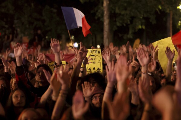 People gather at Republique plaza during a protest against the far-right National Rally party which came out strongly ahead in first-round legislative elections, Sunday, June 30, 2024 in Paris. (AP Photo/Thomas Padilla)