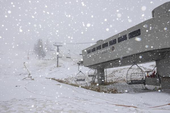 This photo provided by Mammoth Lakes Tourism shows the sky lift during the first snow fall at Mammoth Mountain, Calif. on Tuesday, Nov. 1, 2022. California's first significant storm of the season is bringing rain to the southern half of the state but winter-like conditions persist in the Sierra Nevada after a night of traffic-snarling snowfall. (Patrick Griley/Mammoth Lakes Tourism via AP)