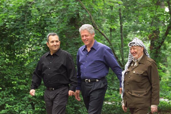 FILE - President Bill Clinton, center, Israeli Prime Minister Ehud Barak, left, and Palestinian leader Yasser Arafat walk on the grounds of Camp David, Md., at the start of the Mideast summit on July 11, 2000. The documentary "The Human Factor" shows the behind-the-scenes story of the U.S.'s effort to secure peace in the Middle East. (AP Photo/Ron Edmonds, File)