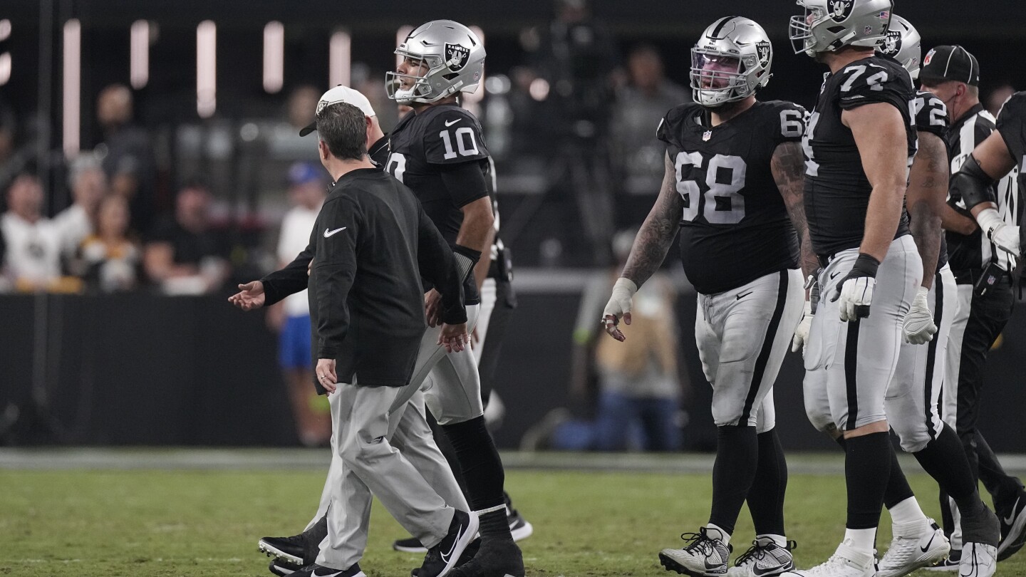 Fans attend an NFL football game between the Raiders and the