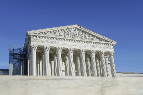 The U.S Supreme Court is photographed on Friday, Jan. 5, 2024, in Washington. The Supreme Court is allowing Idaho to enforce its strict abortion ban, even in medical emergencies, while a legal fight continues. The justices on Jan. 5, said they would hear arguments in the case in April and put on hold a lower court ruling that had blocked the Idaho law in hospital emergencies, based on a lawsuit filed by the Biden administration. (AP Photo/Mariam Zuhaib)