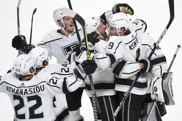 Los Angeles Kings' Adrian Kempe (9) celebrates with teammates after scoring the game-winning goal against the Montreal Canadiens during overtime in NHL hockey game Tuesday, Nov. 9, 2021, in Montreal. (Paul Chiasson/The Canadian Press via AP)