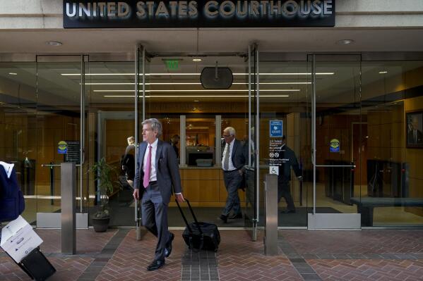 Robert Walters, center, an attorney representing three LIV Golf players, leaves a federal courthouse in San Jose, Calif., Tuesday, Aug. 9, 2022. A federal judge has ruled that three golfers who joined Saudi-backed LIV Golf will not be able to compete in the PGA Tour's postseason. (AP Photo/Godofredo A. Vásquez)