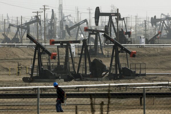 FILE - This Jan. 16, 2015, file photo shows pumpjacks operating at the Kern River Oil Field in Bakersfield, Calif., which is overseen by the U.S. Bureau of Land Management. Oil production from fede...