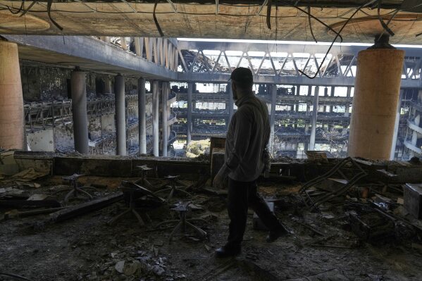 A man walks in the damaged headquarters of Islamic Republic of Iran Broadcasting, Iranian state television, in Tehran, Iran, Thursday, June 19, 2025. (AP Photo/Vahid Salemi)