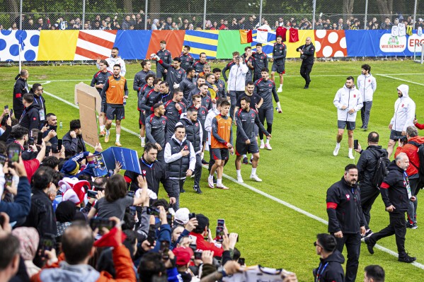 The Turkish national soccer team arrives for a training session ahead of the Euro 2024 soccer tournament in Barsinghausen, Germany, Wednesday, June 12, 2024. (Moritz Frankenberg/dpa via AP)