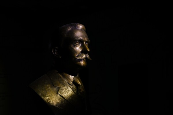 The bronze bust of the French Baron Pierre de Coubertin stands at the entrance of the Hellenic Olympic Committee building in Athens, onTuesday, April 2, 2024. On a personal level, his life was marred by family tragedy that might explain his single-minded dedication to the Olympics. His son suffered severe brain damage at a young age, and his daughter struggled with mental health issues throughout her life. Coubertin had no other children, and two close nephews were killed in World War I. (AP Photo/Petros Giannakouris)