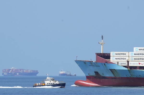 A cargo ship sails toward the Pacific Ocean after its transit though the Panama Canal, as seen from Panama City, Thursday, Aug. 3, 2023. The Panama Canal Authority said it is limiting traffic to 32 daily ship transits through the canal after months of drought and expect less income in 2024 due to the ongoing water crisis. (AP Photo/Arnulfo Franco)