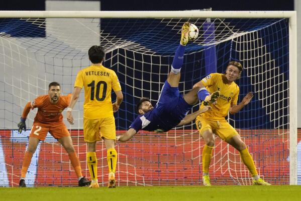 Dinamo's Bruno Petkovic scores on a bicycle kick his side's second goal during the Champions League play-off soccer match, second leg, between Dinamo Zagreb and FK Bodo/Glimt at the Maksimir stadium in Zagreb, Croatia, Wednesday, Aug. 24, 2022. (AP Photo/Darko Bandic)