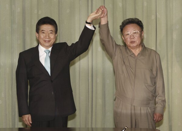 
              FILE - In this Oct. 4, 2007 file photo, South Korean President Roh Moo-hyun, left, holds hands with North Korean leader Kim Jong Il after exchanging a joint declaration documents in Pyongyang, North Korea. The first inter-Korean summit in more than a decade follows meetings between Kim Jong Un’s father, Kim Jong Il, with South Korean presidents in 2007 and 2000. Each produced similar sounding vows to reduce tensions, replace the current armistice that ended the fighting in the 1950-53 Korean War and expand cross-border engagement. (Yonhap Pool Photo via AP, File)
            