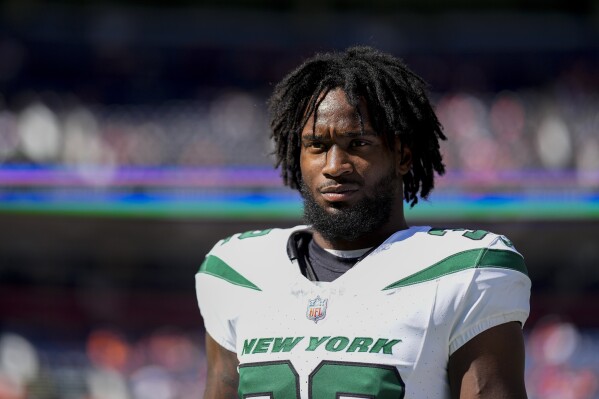 FILE - New York Jets running back Michael Carter looks on against the Denver Broncos before an NFL football game, Oct. 8, 2023, in Denver. The Jets waived Carter on Tuesday, Nov. 14. (AP Photo/Jack Dempsey, File)