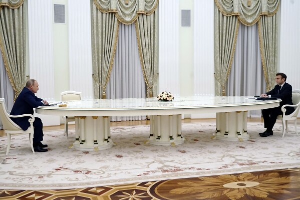 FILE - Russian President Vladimir Putin, left, listens to French President Emmanuel Macron during their meeting in the Kremlin in Moscow, Russia, Feb. 7, 2022. French President Emmanuel Macron said Friday, Dec. 15, 2023, he would still consider talking with his Russian counterpart Vladimir Putin if it helps creating a “sustainable peace” between Ukraine and Russia.Macron and Putin enjoyed a good working relationship before Russia invaded its neighbor in Feb. 22, 2022. In the weeks preceding the start of the war, Macron's diplomatic efforts failed but he then kept an open line of communication with the Russian head of state for months. (Sputnik, Kremlin Pool Photo via AP, File)