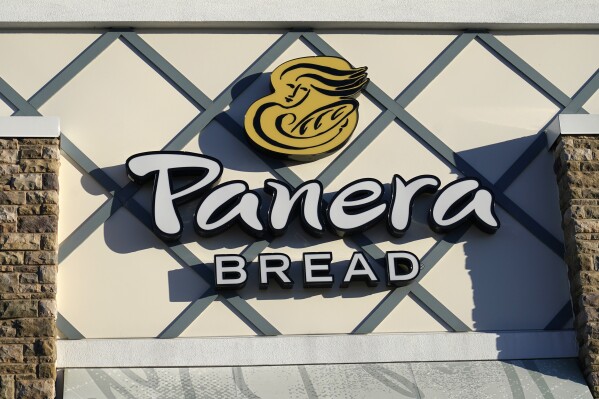 FILE - A Panera Bread logo is attached to the outside of a Panera Bread restaurant location, Dec. 20, 2022, in Westwood, Mass. The family of a 46-year-old Florida man has filed a wrongful death and negligence lawsuit against Panera, claiming its caffeine-filled lemonade drink led to his death. (AP Photo/Steven Senne, File)