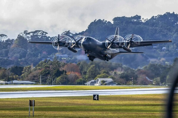 A RNZAF Hercules C-130 takes off from Whenuapai airbase near Auckland, New Zealand, bound for Noumea, New Caledonia, on a mercy mission to rescue stranded New Zealand tourists, Tuesday, May 21, 2024. The Australian and New Zealand governments say they are sending planes to evacuate their nationals from violence-scorched New Caledonia. (Michael Craig/NZ Herald via AP)