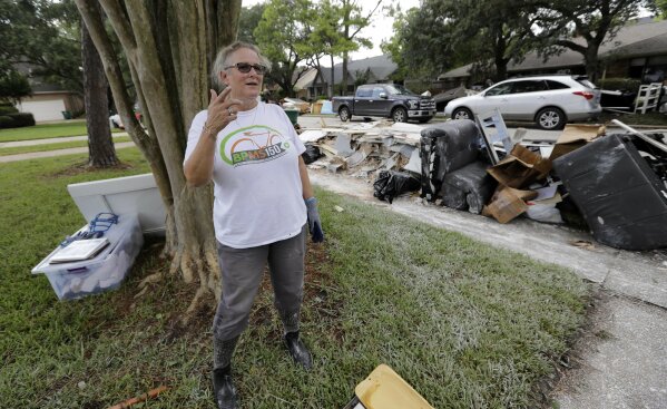 
              Barron Lazano talks about surviving and damage caused to her home in the aftermath of Harvey Wednesday, Aug. 30, 2017, in Houston. Harvey did not discriminate in its destruction. It raged through neighborhoods rich and poor, black and white, upscale and working class. Across Houston and surrounding communities, no group sidestepped its paralyzing deluges and apocalyptic floods.(AP Photo/David J. Phillip)
            