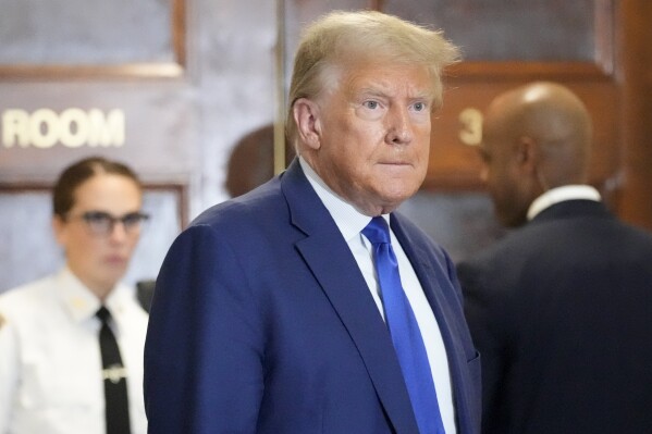 Former President Donald Trump speaks during a break in his civil business fraud trial at New York Supreme Court, Wednesday, Oct. 25, 2023, in New York. The judge in Trump's civil fraud trial has fined the former president $10,000. The judge says Trump violated a limited gag order barring personal attacks on court staffers. (AP Photo/Seth Wenig)
