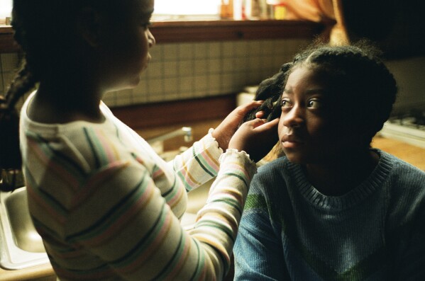 This image released by A24 shows Jayah Henry, left, and Kaylee Nicole Johnson in a scene from "All Dirt Roads Taste of Salt." (A24 via AP)