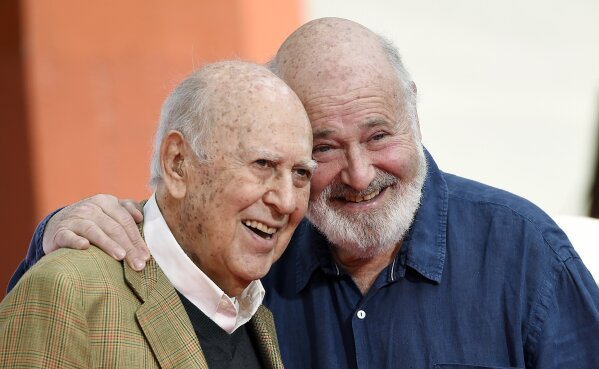 FILE - In this April 7, 2017 file photo, Carl Reiner, left, and his son Rob Reiner pose together following their hand and footprint ceremony at the TCL Chinese Theatre in Los Angeles. Carl Reiner, the ingenious and versatile writer, actor and director who broke through as a “second banana” to Sid Caesar and rose to comedy’s front ranks as creator of “The Dick Van Dyke Show” and straight man to Mel Brooks’ “2000 Year Old Man,” has died, according to reports. Variety reported he died of natural causes on Monday night, June 29, 2020, at his home in Beverly Hills, Calif. He was 98. (Photo by Chris Pizzello/Invision/AP, File)