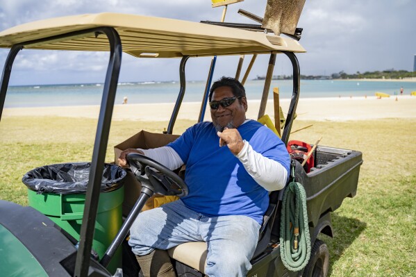 Don Herring, a park groundskeeper at the Ala Moana Regional Park, flashes a shaka during an interview on Wednesday, March 6, 2024, in Honolulu, Hawaii. (AP Photo/Mengshin Lin)