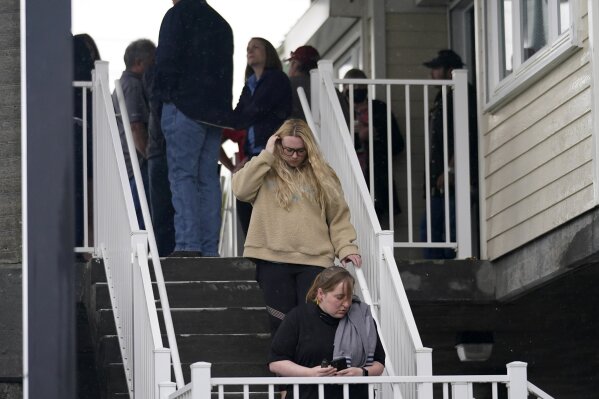 People leave a briefing for family members by Coast Guard and NTSB officials in Port Fouchon, La., Friday, April 16, 2021, after a lift boat capsized in the Gulf of Mexico during a storm on Tuesday. (AP Photo/Gerald Herbert)