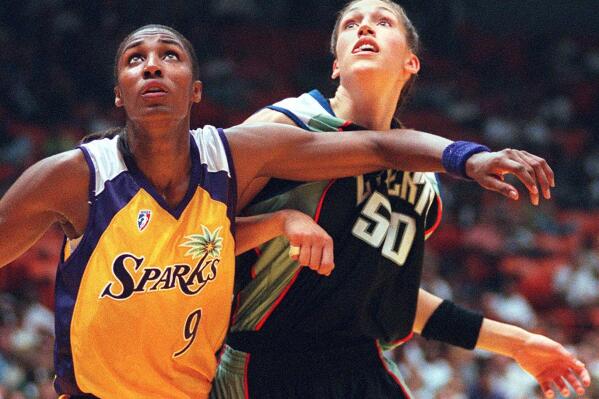 FILE - Los Angeles Sparks' Lisa Leslie, left, and the New York Liberty's Rebecca Lobo battle for rebound position during the first half of a WNBA basketball game in Inglewood, Calif. The NBA recognized the popularity of the women's game with the league's Board of Governors approving plans to start a new pro basketball league in the summer of 1997. (AP Photo/Kevork Djansezian, File)