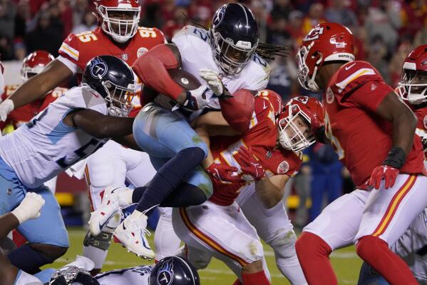 Tennessee Titans running back Derrick Henry (22) runs with the ball as Kansas City Chiefs linebacker Leo Chenal (54) defends during the second half of an NFL football game Sunday, Nov. 6, 2022, in Kansas City, Mo. (AP Photo/Ed Zurga)