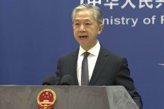 Chinese Foreign Ministry spokesperson Wang Wenbin speaks during the daily briefing in Beijing, Friday, July 14, 2023. China on Friday criticized a German government call for reducing dependency on Chinese products and reducing other potentially unstable factors in bilateral relations, calling it a form of protectionism. (AP Photo/Liu Zheng)