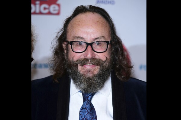 FILE - Dave Myers attends the TV Choice Awards 2017 at the Dorchester Hotel, London, Sept. 4, 2017. Myers, best known as one half of Britain’s adored “Hairy Bikers” TV chef duo, has died after a battle with cancer. He was 66. His co-star and long-time friend Si King said in a post on social media that Myers died peacefully at home Wednesday, Feb. 28, 2024. Myers and King found fame in the U.K. and beyond with their “Hairy Bikers” TV series, an unlikely combination of motorbike travel show, humor and cookery program. (Ian West/PA via AP, File)